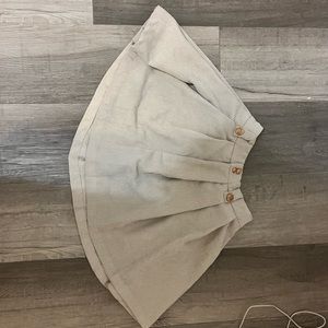 tan skirt with gold buttons